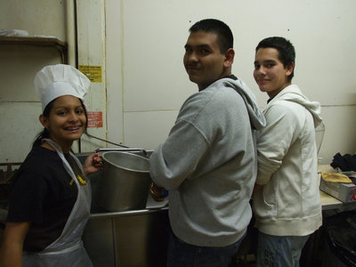 Image: The smiles are still there even during cleanup — Laura Luna, Yonaton Davila and Braulio Luna handle the suds during the cleanup part of the evening.