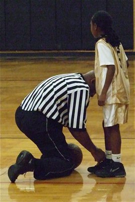 Image: Thanks Mr. Referee — Kambria Brooks(5) gets a little help from Mr. Referee.