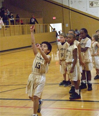 Image: Michael lofts a shot — Michael Gonzalez(13) takes his best shot.