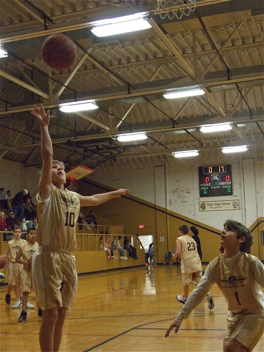 Image: Caden Petrey — Caden Petrey(10) practices a layup as Levi McBride(1) prepares to get the rebound.