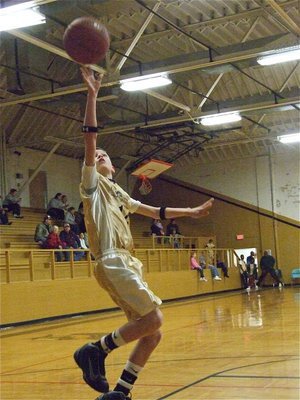 Image: Ty Windham — Ty Windham(12) puts in a layup before the game.