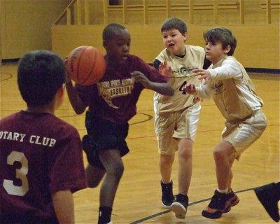 Image: Trying to trap — Thomas Crowell(4) and Levi McBride(1) try to trap a Hillsboro Maroon dribbler.