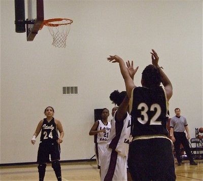 Image: Fleming fires away — Alyssa Richards(24) watches as Jaleecia Fleming(32) gets the shot away.