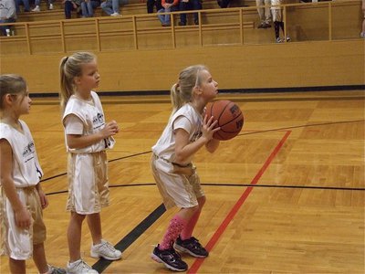 Image: Mott takes aim — Lacy Mott attempts a free throw worth 1-point before the 2nd half starts as teammates Alex Jones(10) and Abigail Evans(3) look on.