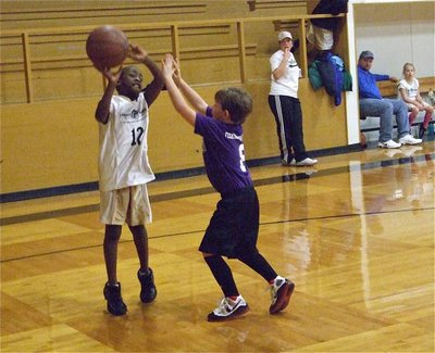 Image: Jaylon Davis — Jaylon Davis(12) puts up a jump shot over Hillsboro Purple.
