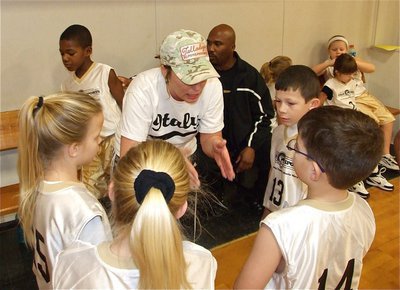 Image: Consultant — Dustie Jones, who doesn’t consider herself a coach, offers guidance to the team during a timeout.