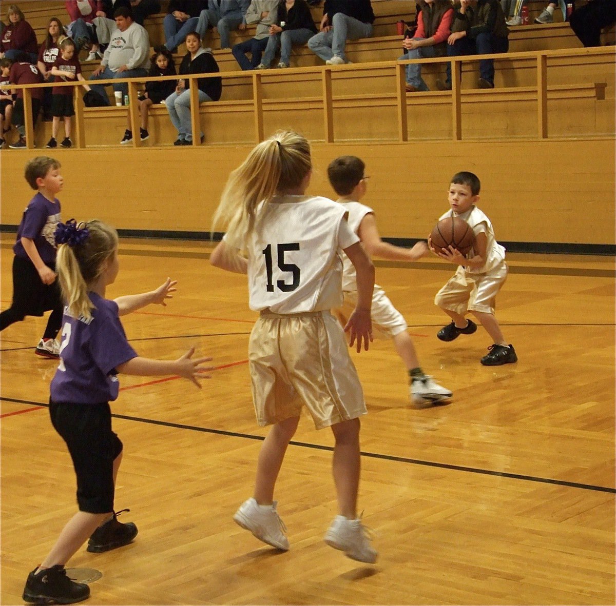 Image: Mason’s got the ball — Alex Jones(15) posts up while Mason “Animal” Griffin(13) and Gage Wafer(14) get control of the ball.