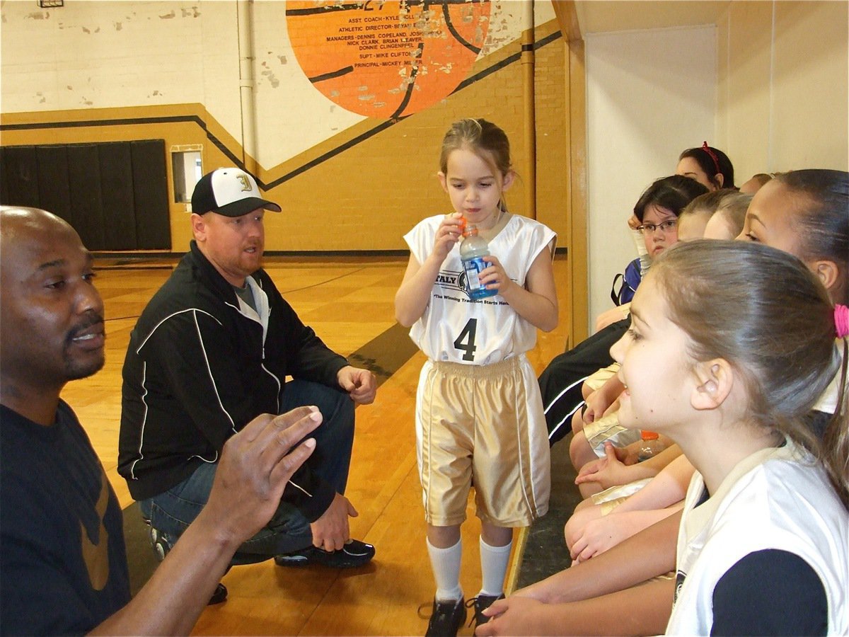 Image: Let’s talk this thru — Coaches Derrick Cunningham and Allen Richards educate the girls during a break in the action.