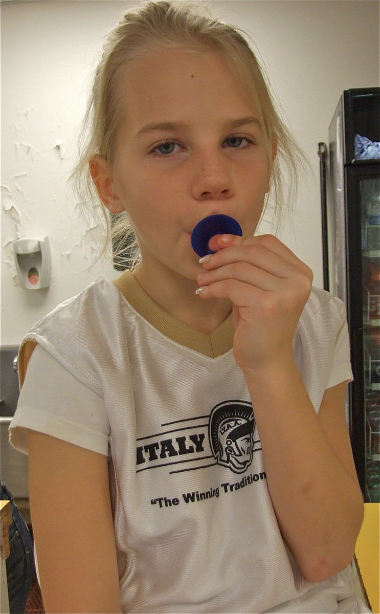 Image: Precious — Lacy Mott enjoys a treat at the concession stand that featured nachos with chilli and cheese, hot dogs, chocolate and powdered donuts, popcorn and Gladiatorade!