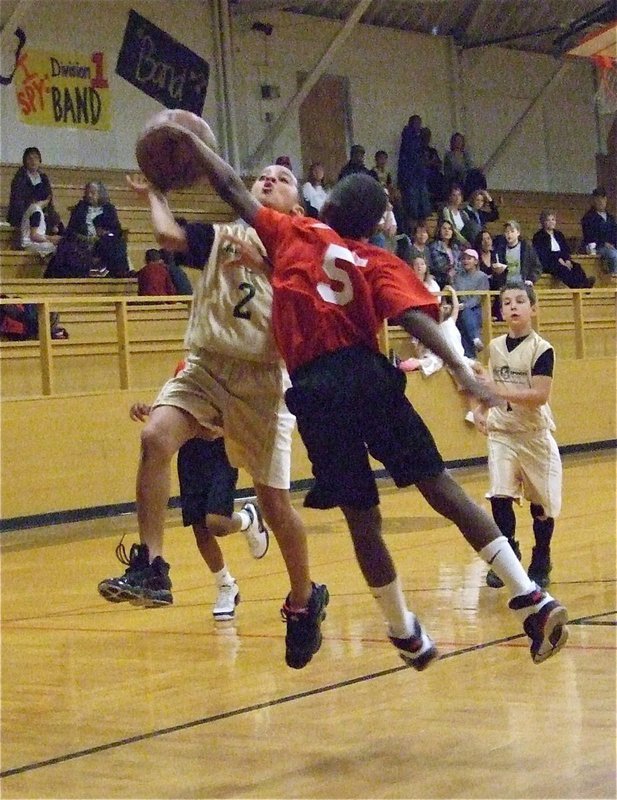 Image: Air attack — Tylan Wallace(2) takes it to the rack with little disregard for his safety.