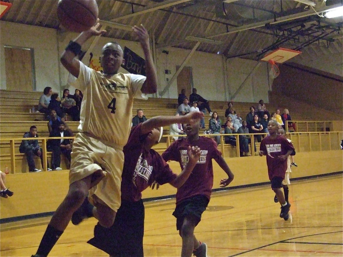 Image: Nothing comes easy — Oshea Turner(4) charges toward the basket against Hillsboro Maroon.