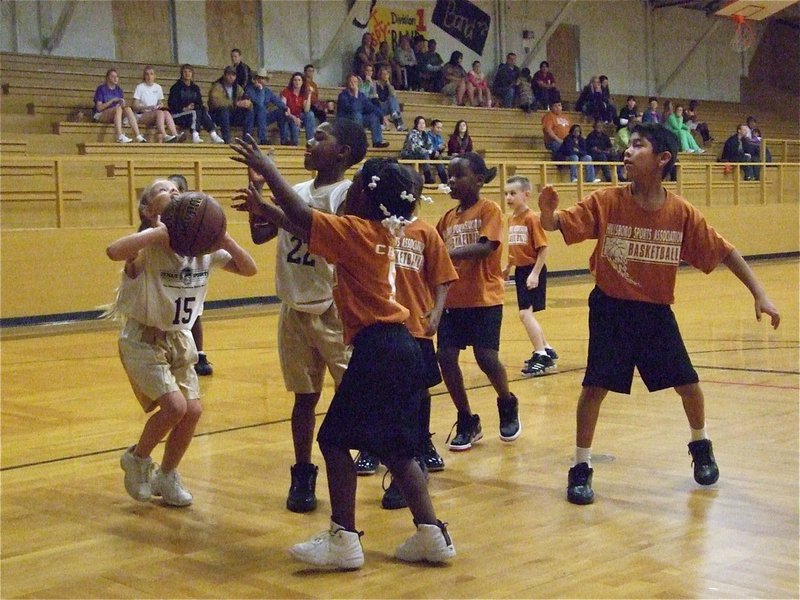 Image: Alex gets open — Alex Jones(15) takes a shot from beneath the basket. 1st and 2nd graders shoot on 8.5 foot goals.
