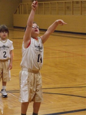 Image: Learning to shoot — Gage Wafer(14) tries to figure out the proper shooting form.