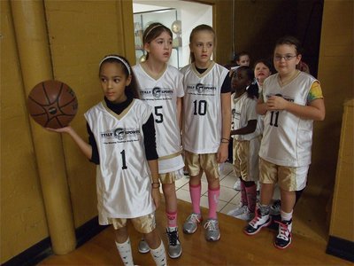Image: 3rd &amp; 4th grade girls — Elisha McClendon(1) gets ready to lead her Italy 14 team onto the court.