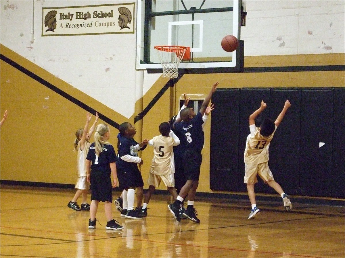 Image: Gonzalez goals for it — Michael Gonzalez(13) puts up a shot as Jacyee Coffman(20) and Kambria Brooks(5) prepare to rebound.