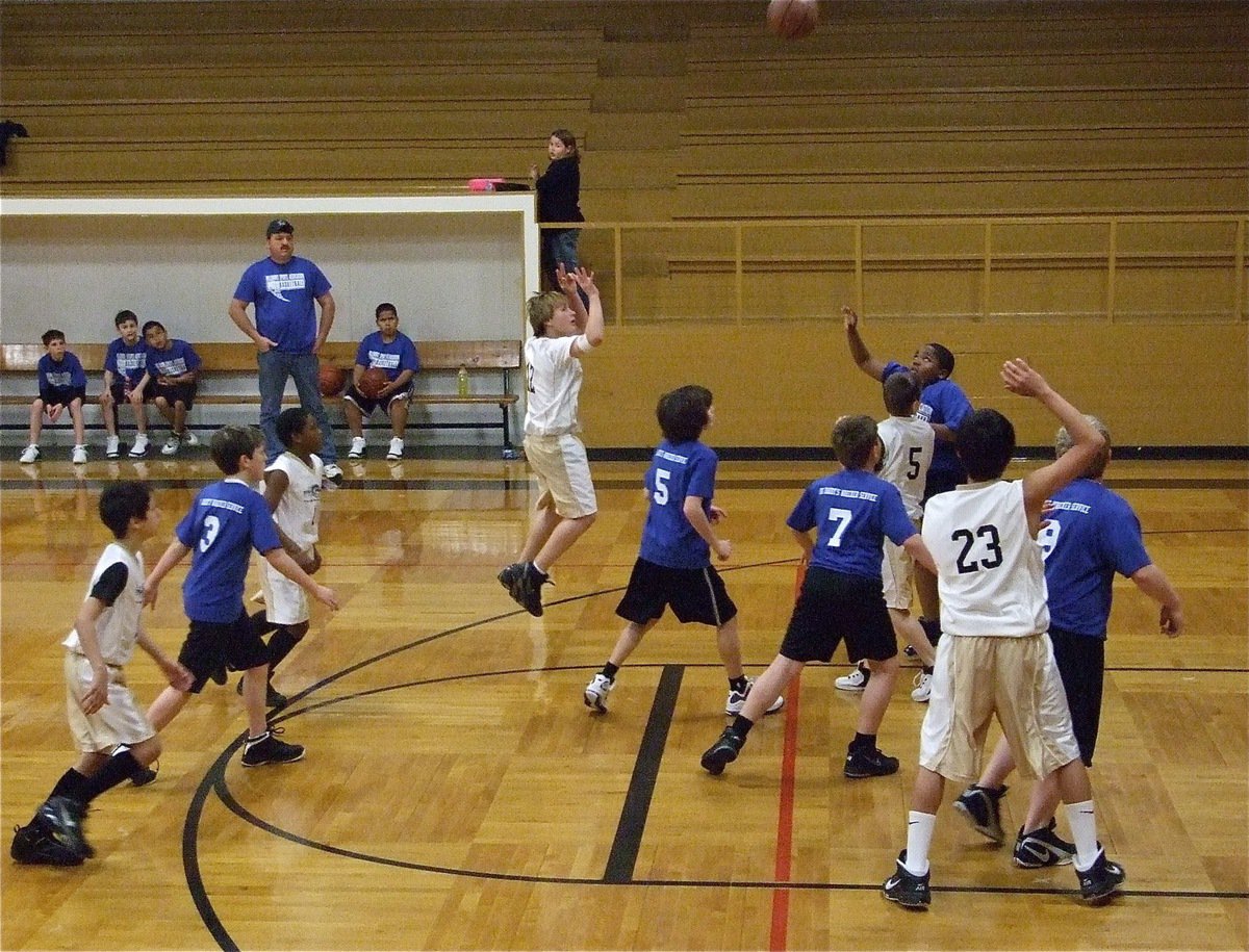 Image: Lance shoots a jumper — Lance McClendon(12) launches a jumper over Hillsboro Royal Blue.