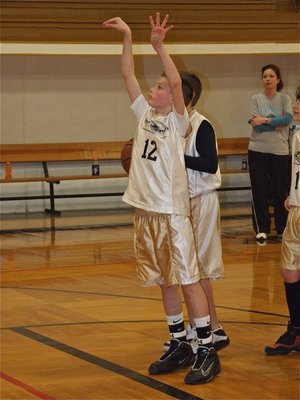 Image: The swan shot — Ty Windham(12) demonstrates the swan technique at the free throw line.