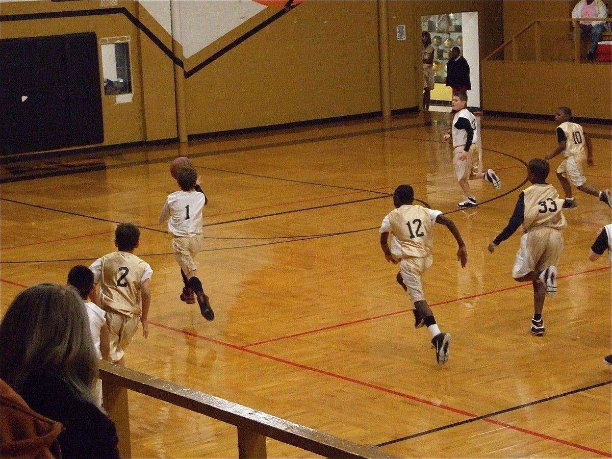 Image: Levi takes off — Levi McBride(1) heads for the basket with the game on the line.