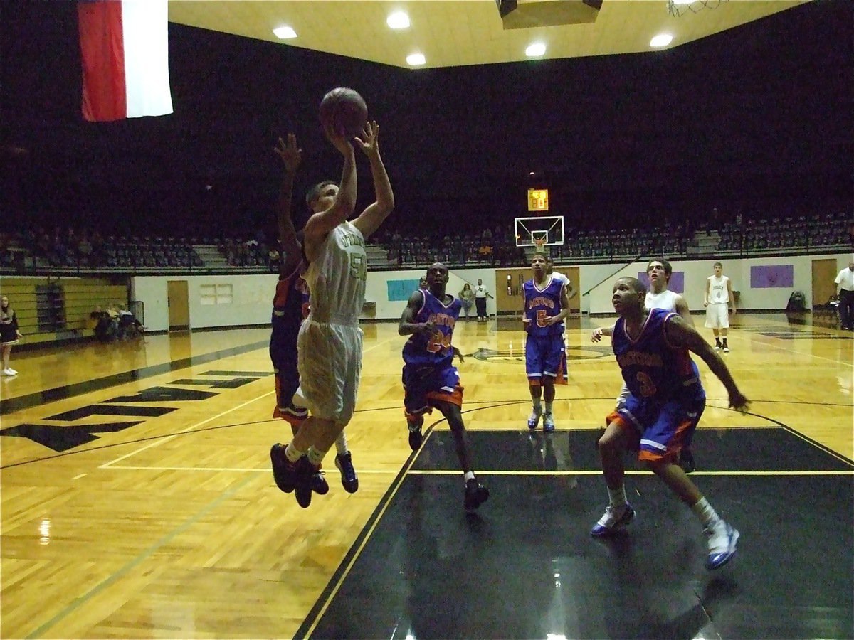 Image: Jackson takes off — Kyle Jackson(50) leaps for the layup.