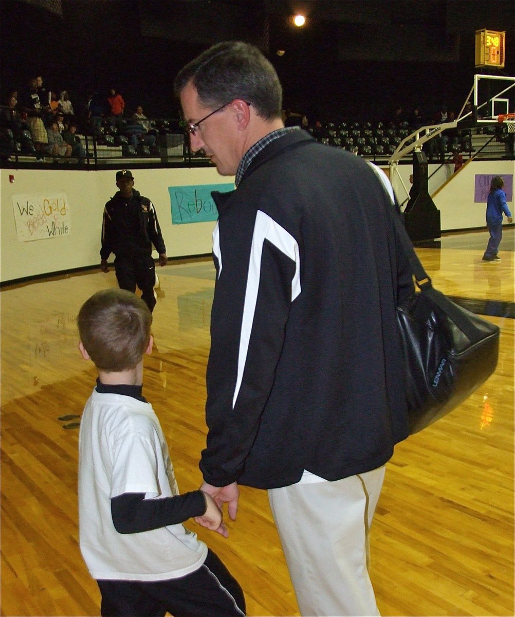 Image: Coach and Dad — Italy Head Coach Kyle Holley gets a “good luck” wish from his son Kort before the game against Gateway.