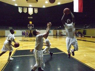 Image: JV warms up — Ta’Cory Green hands to Caden Jacinto, Jake Escamilla rebounds and Corrin Frazier(20) shoots a bank shot.