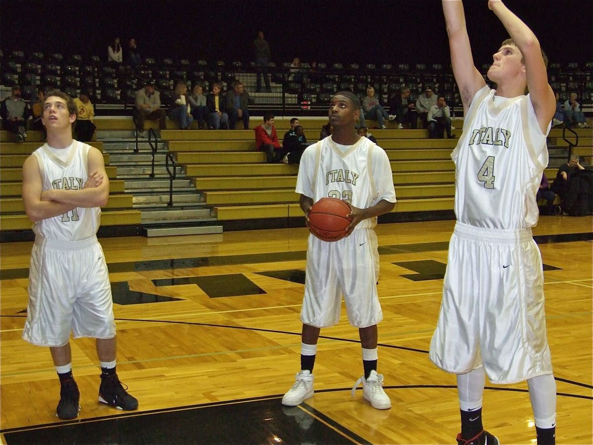 Image: Pre-game warmup — Brandon Souder(11) and Ta’Cory Green(33) check out Jase Holden’s free shot before the Italy JV’s game against Whitney.