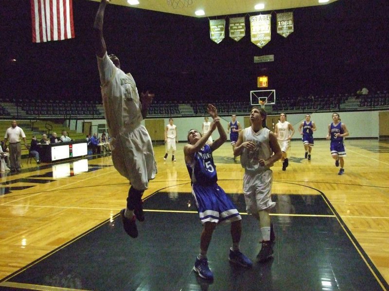 Image: Simmons skies — Devonta Simmons(10) catches some air as he floats toward the basket.