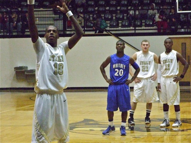 Image: Isaac from the line — John Isaac(10) goes 5-of-6 from the line in 3rd quarter as teammates Kyle Wilkins(21) and Jasenio Anderson(11) look on.