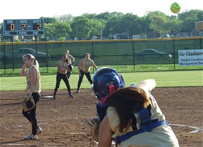 Image: She’s got a cannon! — Catcher Alyssa Richards(12) rockets a throw to second base, perhaps sending a message to the visiting Lady Cougars.