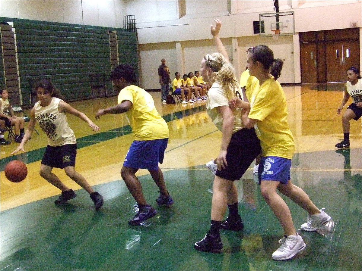 Image: Posting up — Lacie Lopez handles the rock while Shelbi Gilley tries to post inside.