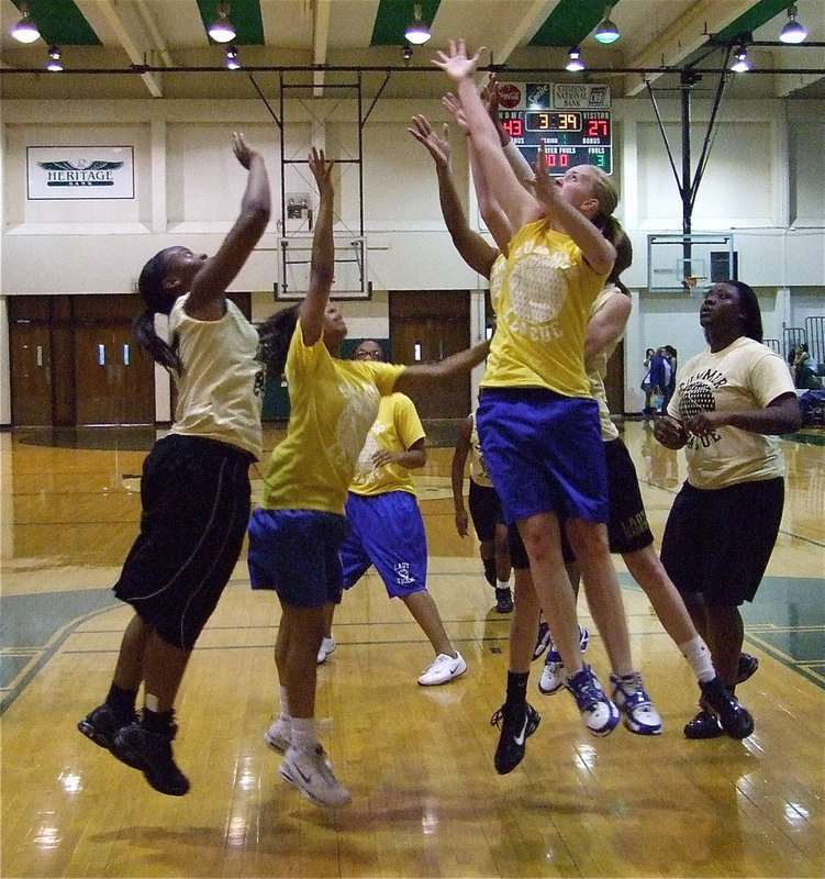 Image: Rebound that ball — Brianna Burkhalter, Kaitlyn Rossa and Jimesha Reed go for a rebound equally enthusiastic Lady Tigers.