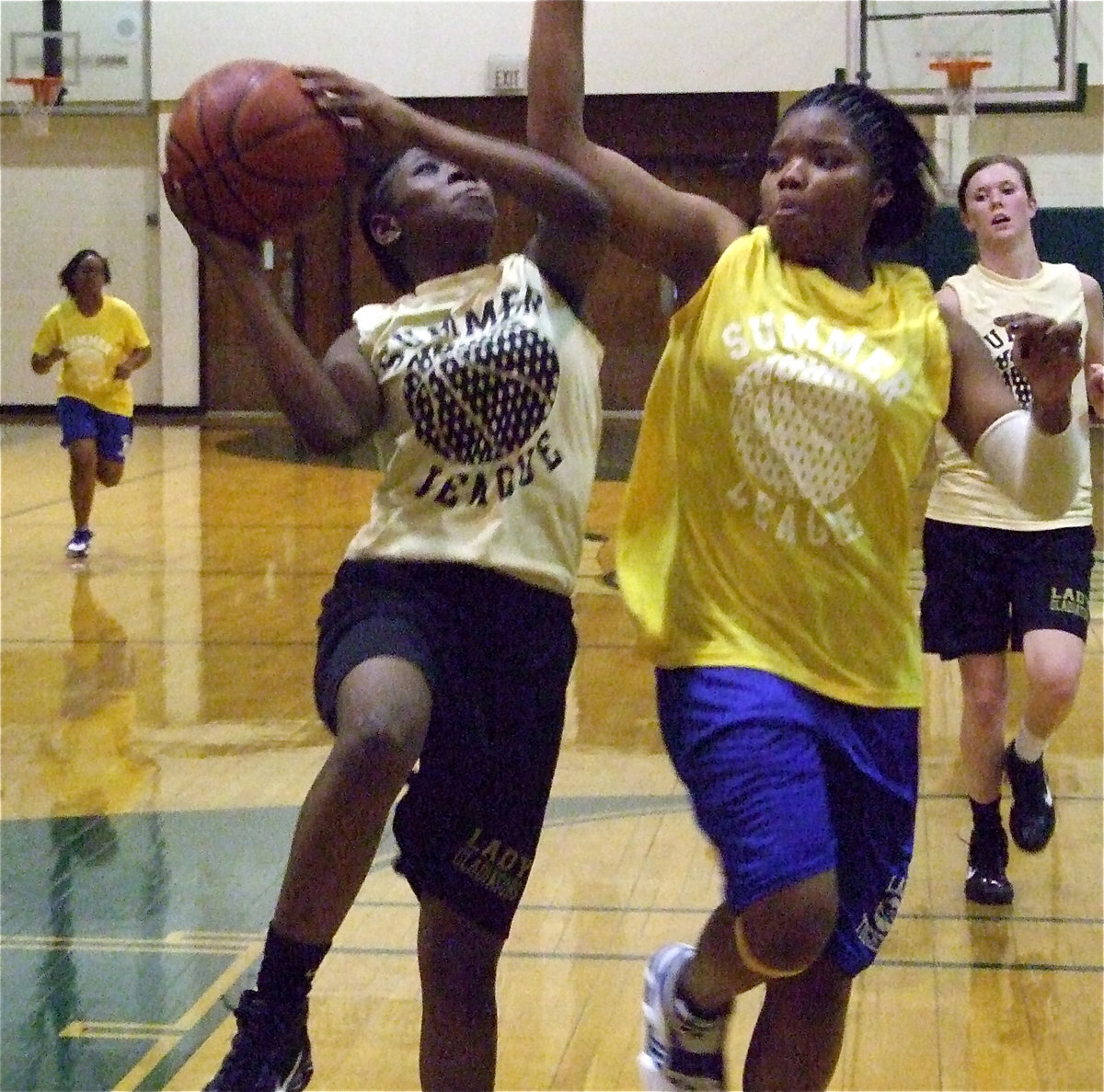 Image: Copeland goes for it — Jameka Copeland takes it to the goal against a Corsicana defender.