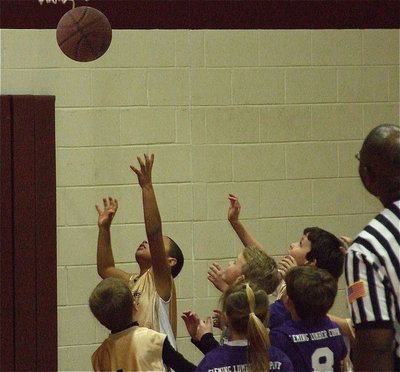 Image: Reaching for a win — 1st and 2nd graders have a ball learning the game.