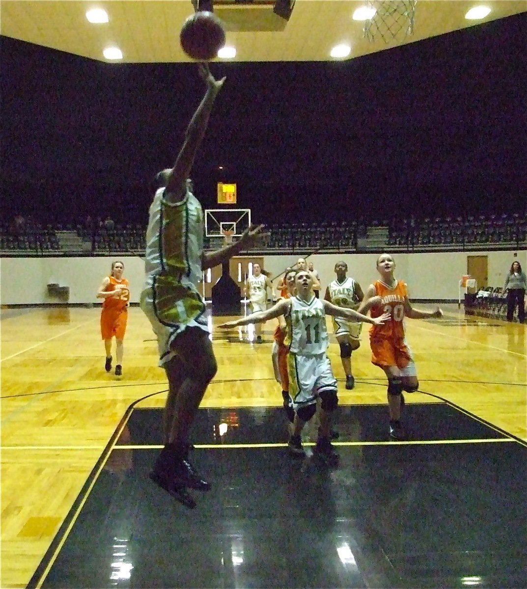 Image: Birdsong fast breaks — Mary Tate(11) holds Aquilla back while Chante Birdsong(5) scores again.