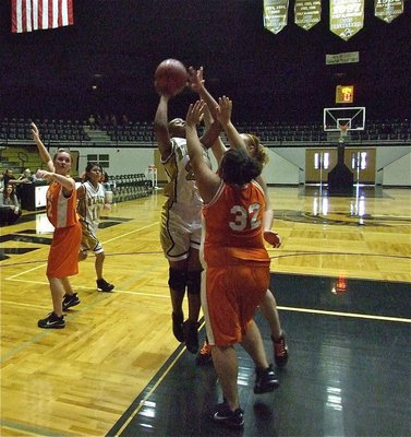Image: Brianna goes up — Brianna Burkhalter(22) goes up strong over the Lady Cougars as Lacie Lopez(10) tries to get to the boards.