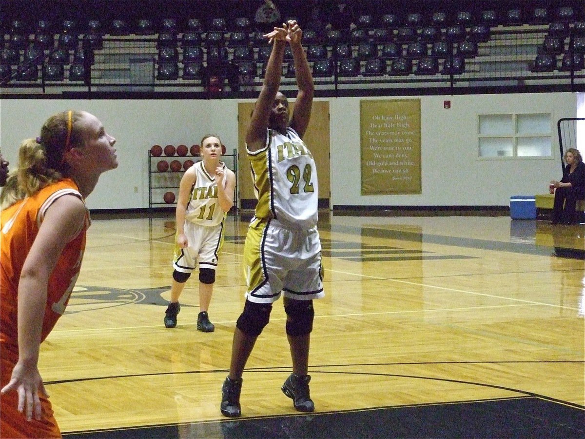 Image: Burkhalter brings it — Brianna Burkhalter(22) shoots a free throw while Mary Tate(11) leans in.