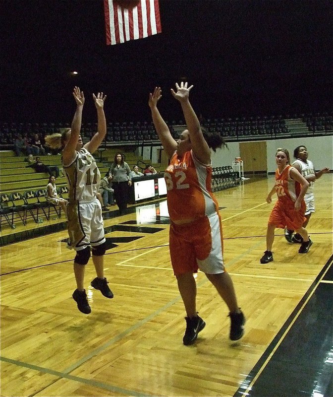 Image: Tate for two — In the midst of a big-time defensive performance, Mary Tate(11) shows she has offensive skills as she shoots over a Lady Cougar.