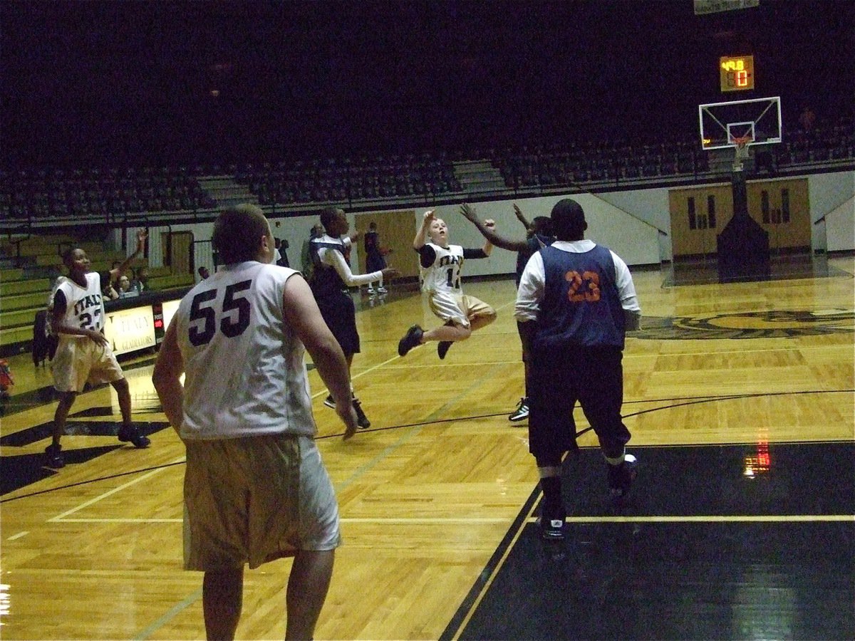 Image: J.T. shoots a jumper — J.T. Escamilla(12) launches a 3-pointer against Hampton Prep.