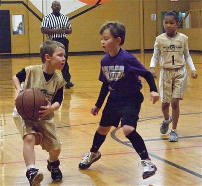 Image: Bryce looks to pass — Bryce DeBorde(4) pushes the ball up the court and looks to pass inside.