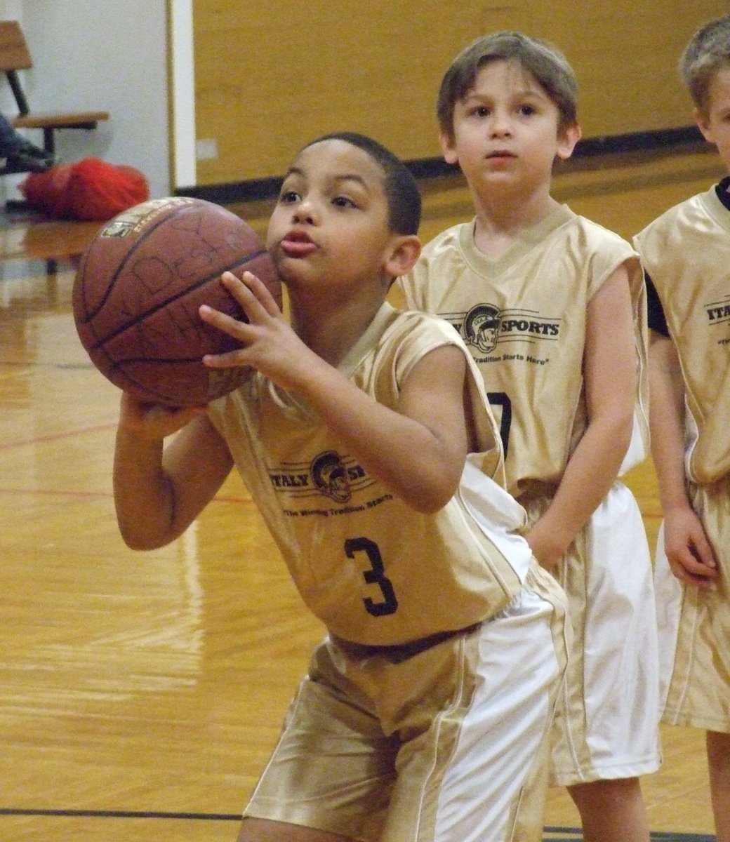 Image: Jones from the line — Cornelius Jones(3) practices free throws while teammate Xander Galvan(10) checks out the crowd.