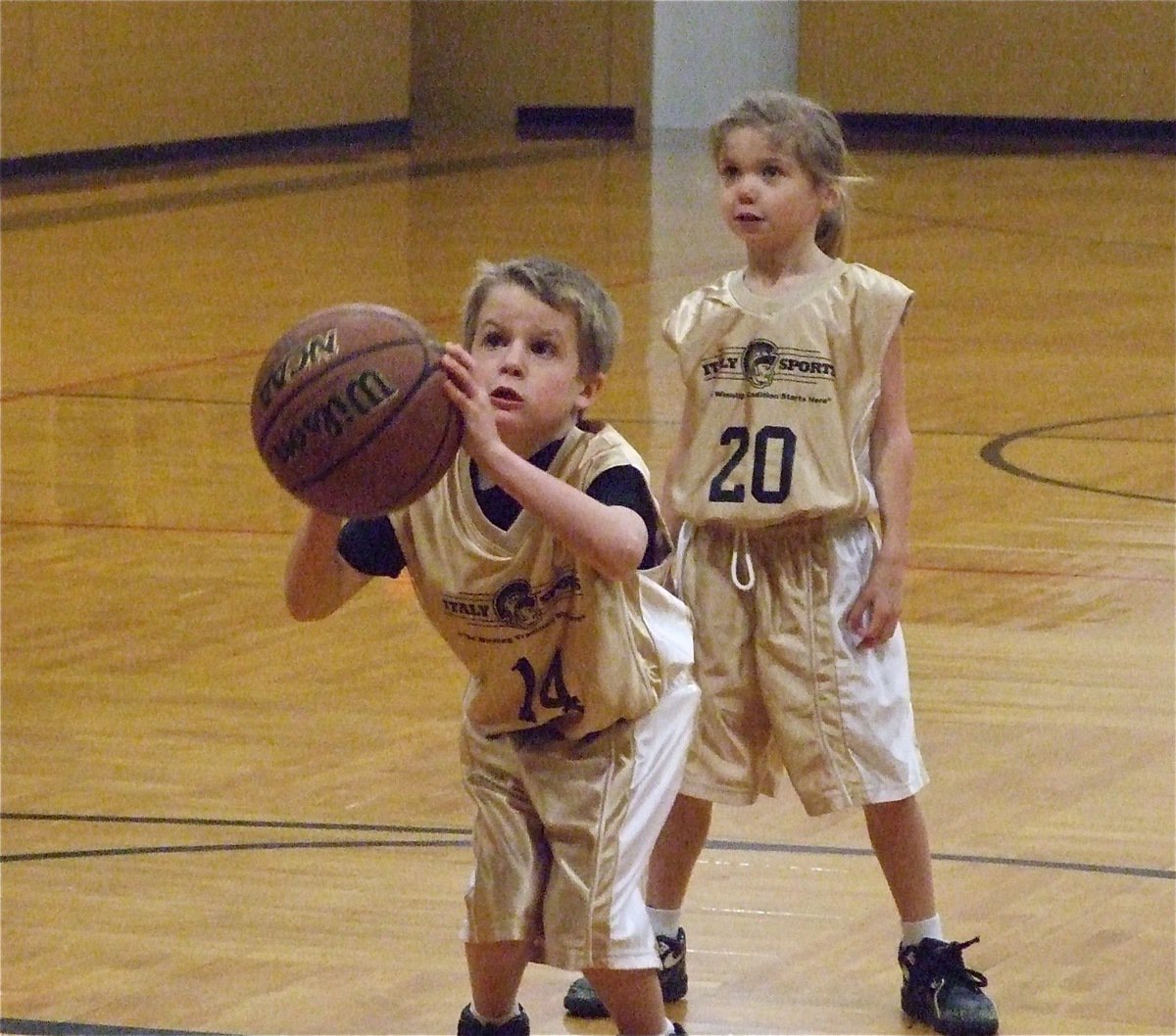 Image: Reese bends low — Reese Janek(14) puts all his muscle behind this shot while teammate Jacee Coffman(20) awaits the result.