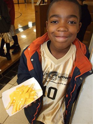 Image: Kendrick snacks — Kendrick Norwood(10) is about to dig in to some french fries.