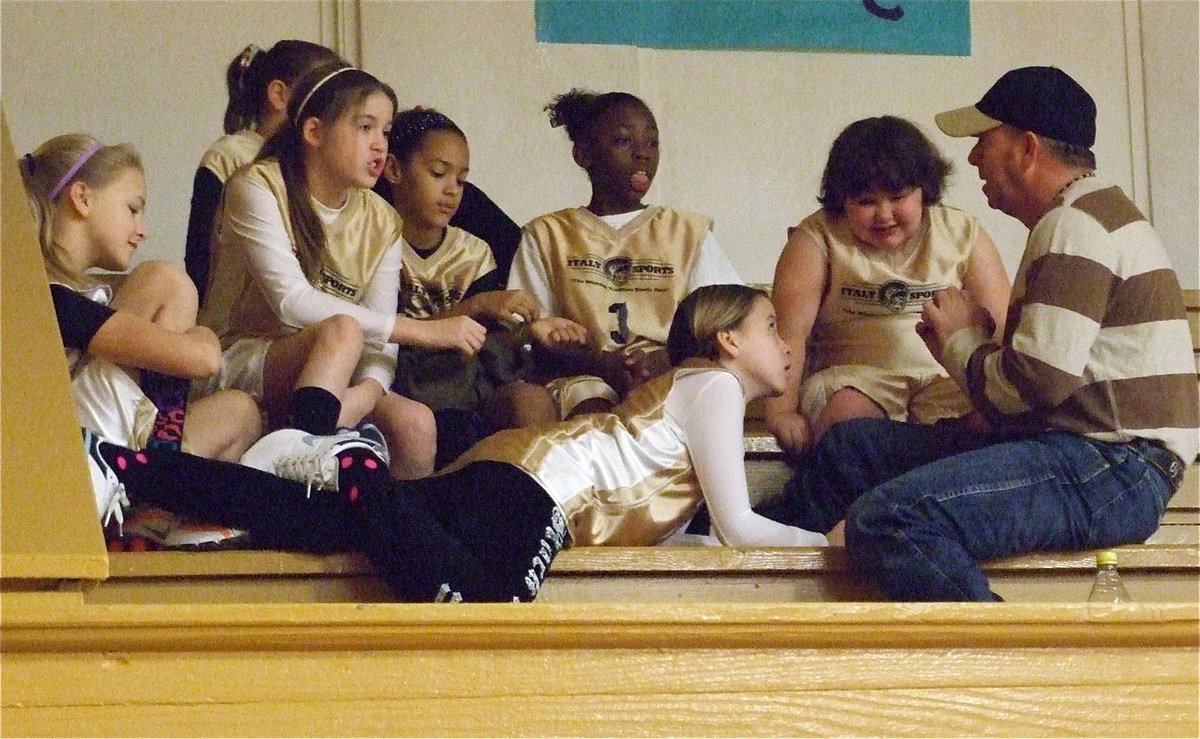 Image: Talking with Coach — Italy 14 coach, Jerry Glenn, talks with his team before their big game.