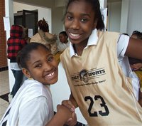 Image: Still friends — After their two teams played against one another, Moesha Griffin(10) and Janae Robertson(23) display good sportsgirlship.