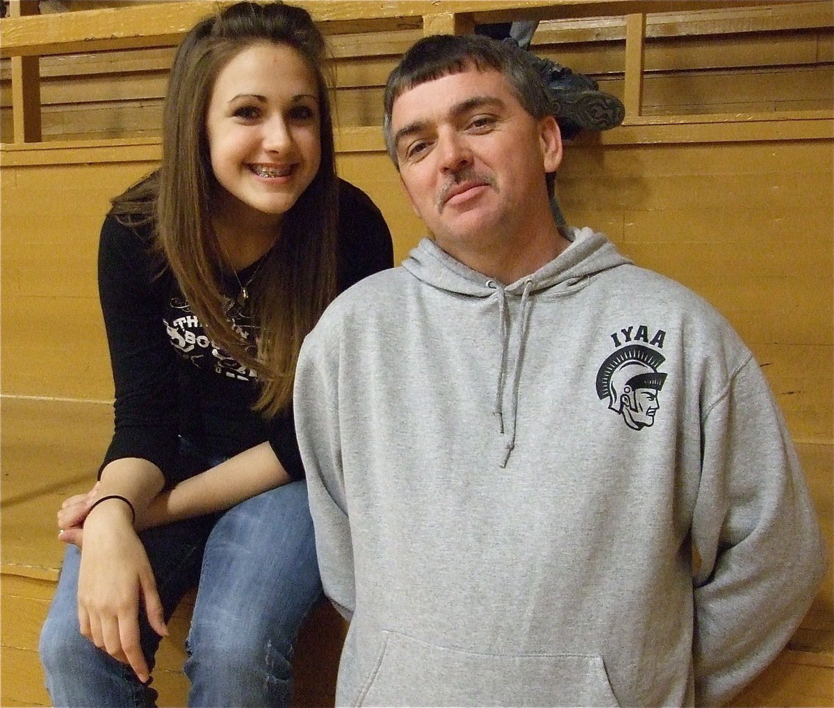 Image: Brianna and Gary — Brianna Perry and IYAA President Gary Wood take a break from helping in the concession stand to enjoy the games.