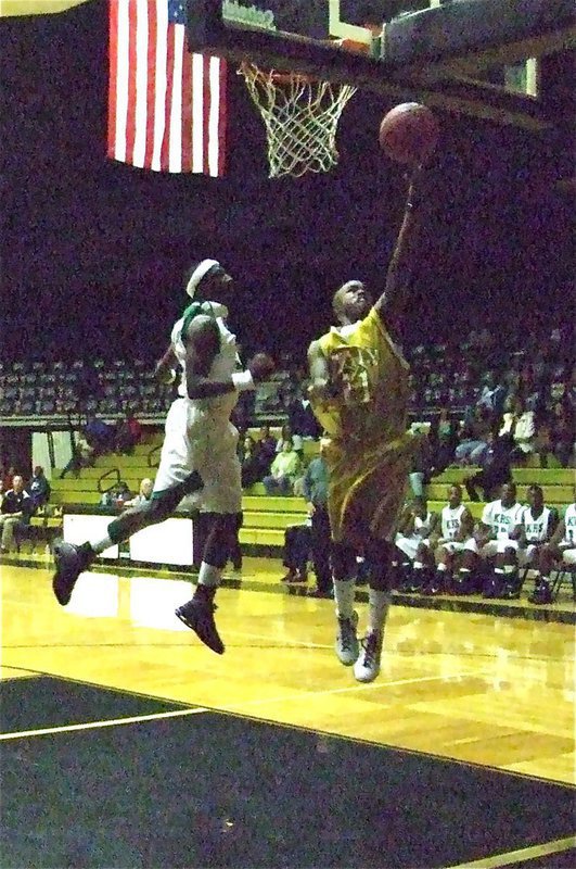 Image: Jasenio glides — Gladiator Jasenio Anderson(11) glides in for two of his 18-points against Kerens during the Tournament Championship game.