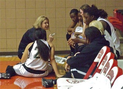 Image: Halftime huddle — Coach McDonald talks strategy with her Lady Gladiators.