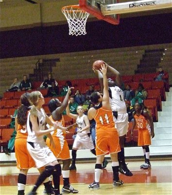 Image: Reed goes up — Jimesha Reed(40) tries to get points for the Lady Gladiators.