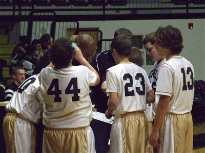 Image: 7th grade huddles — Sensing a chance for a victory, the 7th graders huddle with Coaches Larry Mayberry and Josh Ward late in the contest.