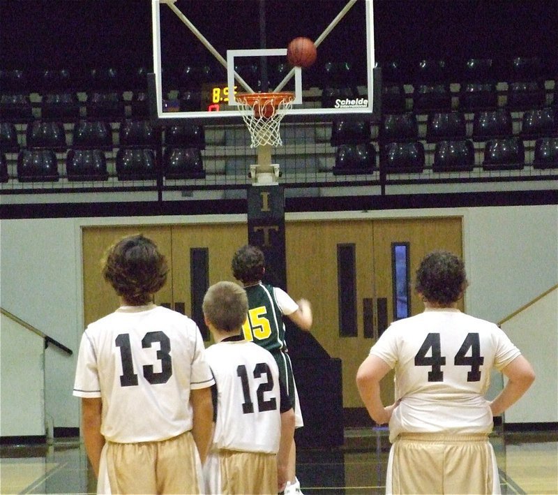 Image: Let’s get technical — Chace McGinnis(13), J.t. Escamilla(12) and John Byers(44) watch Irving North Hills shoot technical foul shots in the second half.